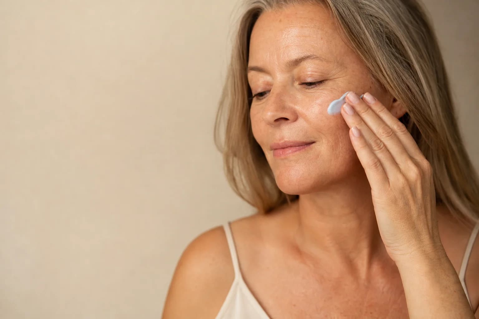 Applying a recovery cream as the final step of an evening skincare routine